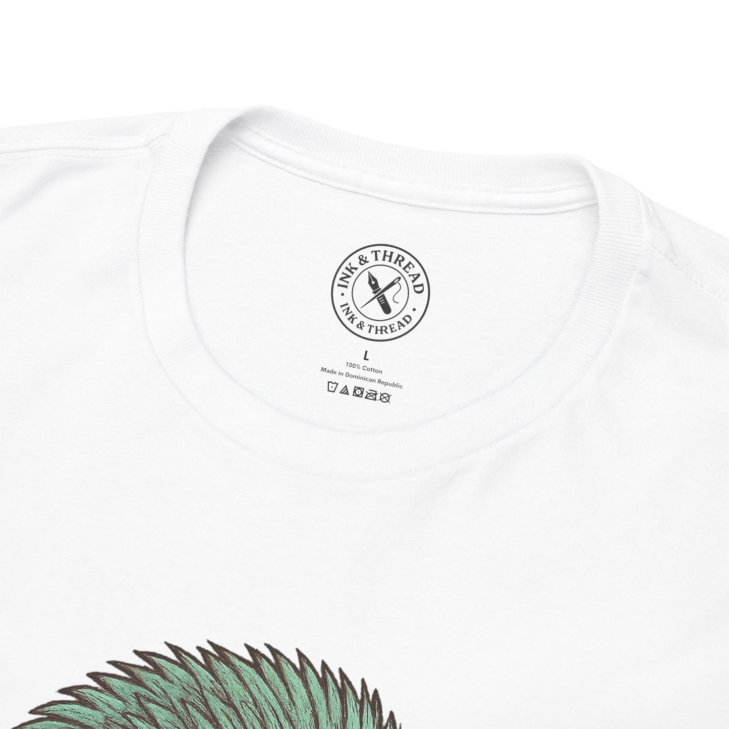 White t-shirt with a brand logo on the chest and green design at the bottom.