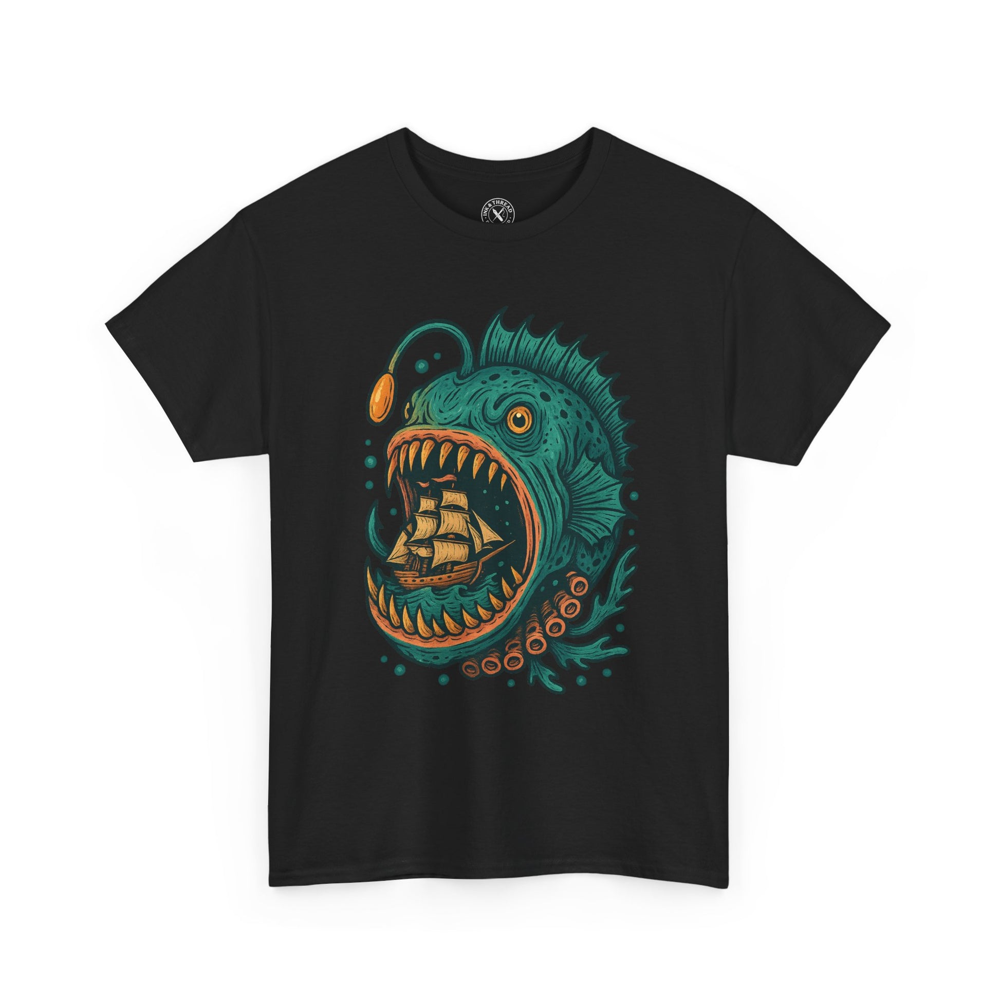 Black t-shirt with a colorful graphic of a fish with an open mouth and a ship inside, on a white background.