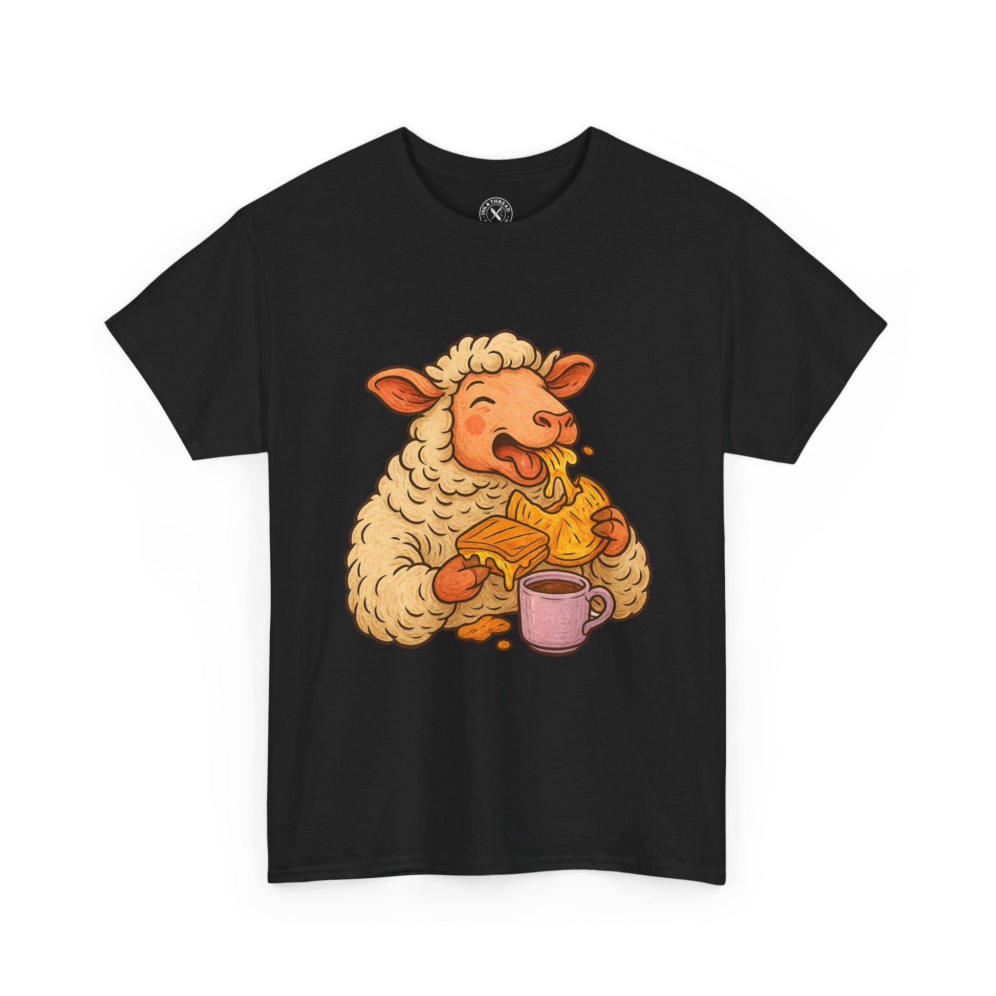 Black t-shirt with a cartoon sheep design holding a mug and a piece of bread on a white background