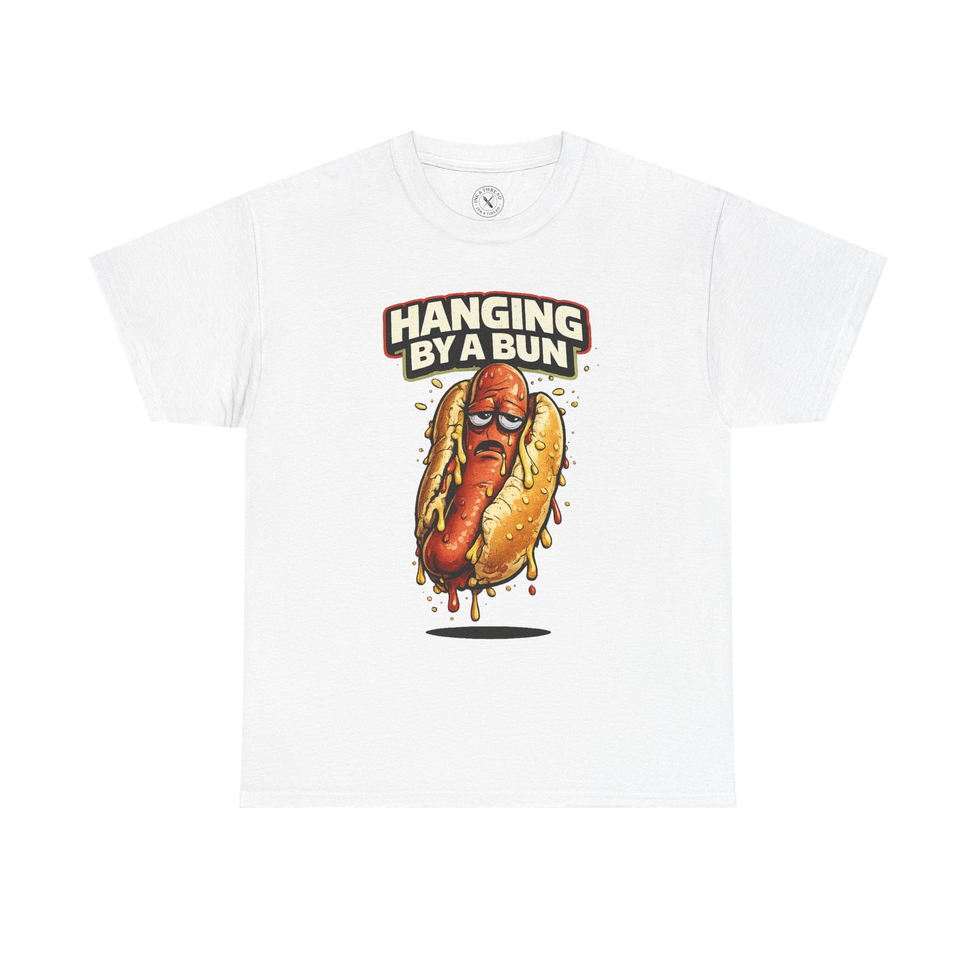 White t-shirt with a hot dog graphic and text 'Hanging By A Bun' on a white background