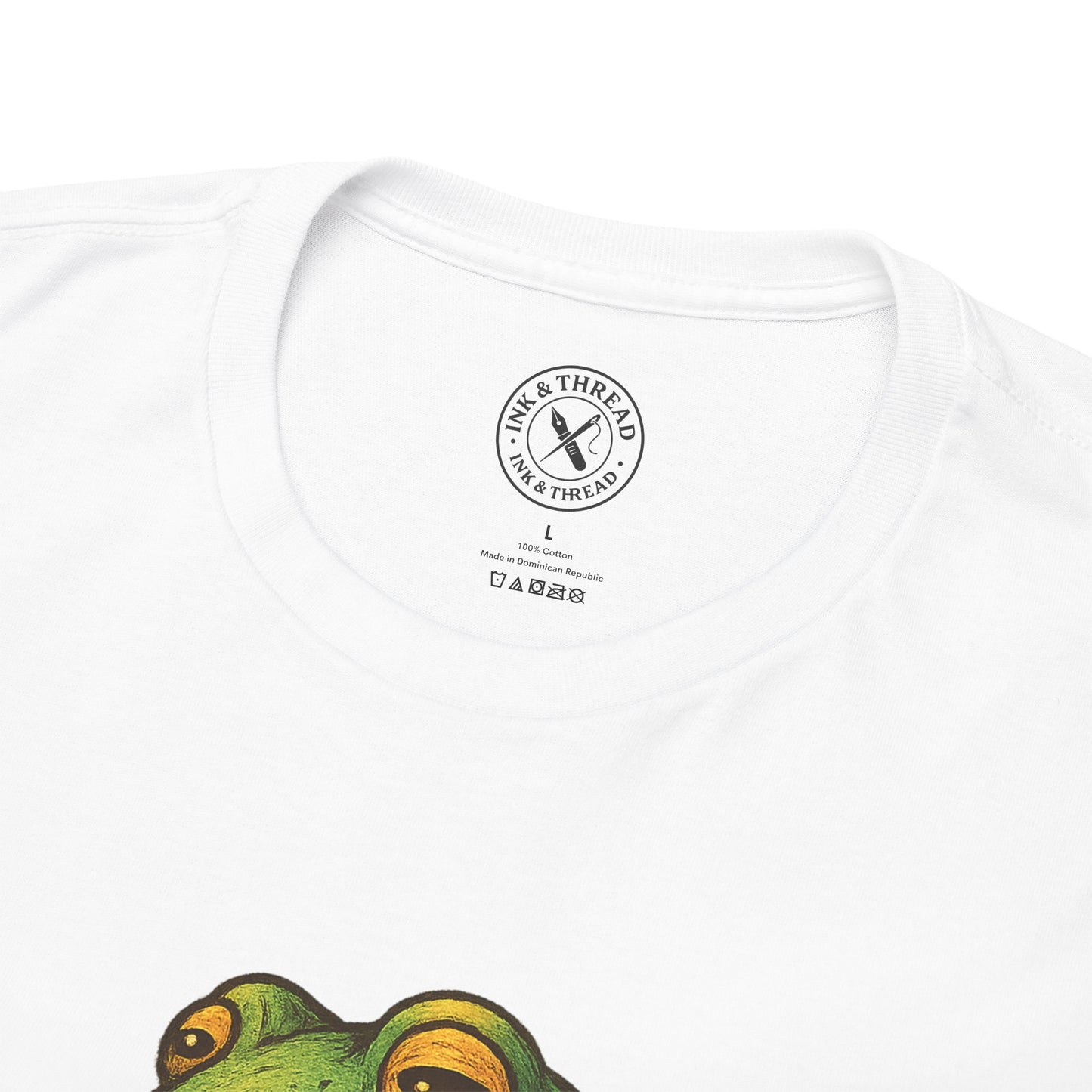 White t-shirt with a green frog graphic and 'Ink & Thread' logo on a white background