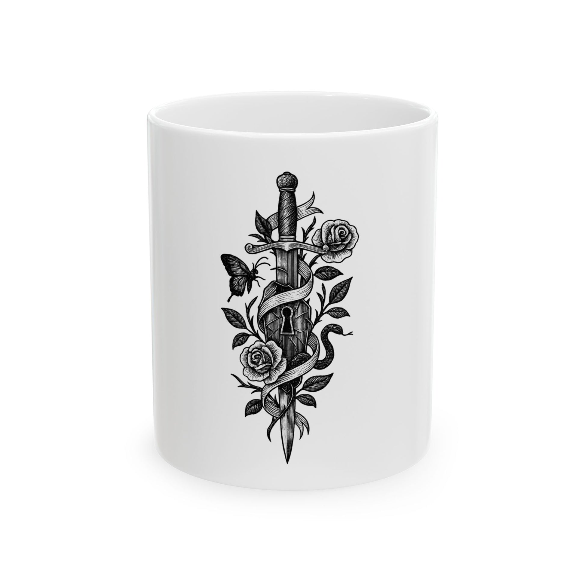 White mug with black tattoo-style design of a dagger, roses, and butterflies on a white background