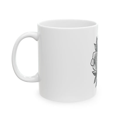 White mug with black floral design on a white background