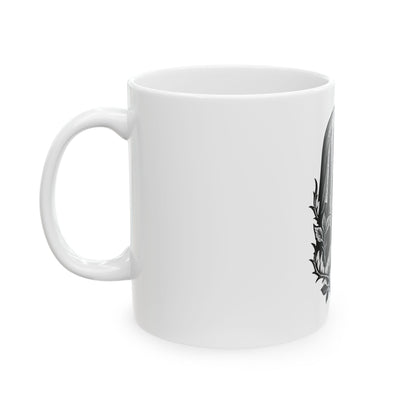 White mug with a black floral design on a white background