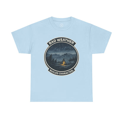 Light blue unisex t-shirt featuring Bad Weather Builds Character camping badge graphic with rainy tent scene and mountain design