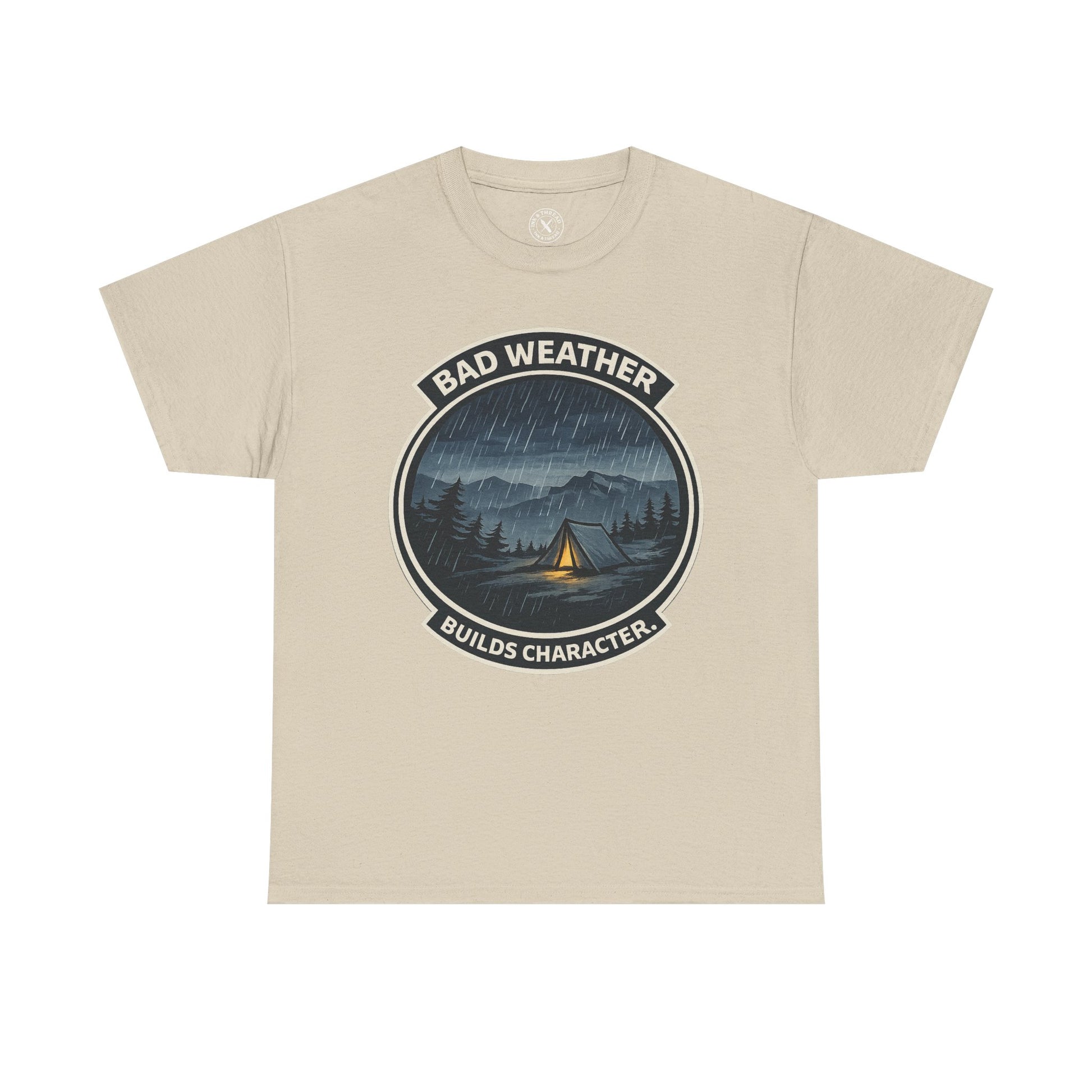 Sand beige unisex t-shirt featuring Bad Weather Builds Character camping badge graphic with rainy tent scene and mountain design