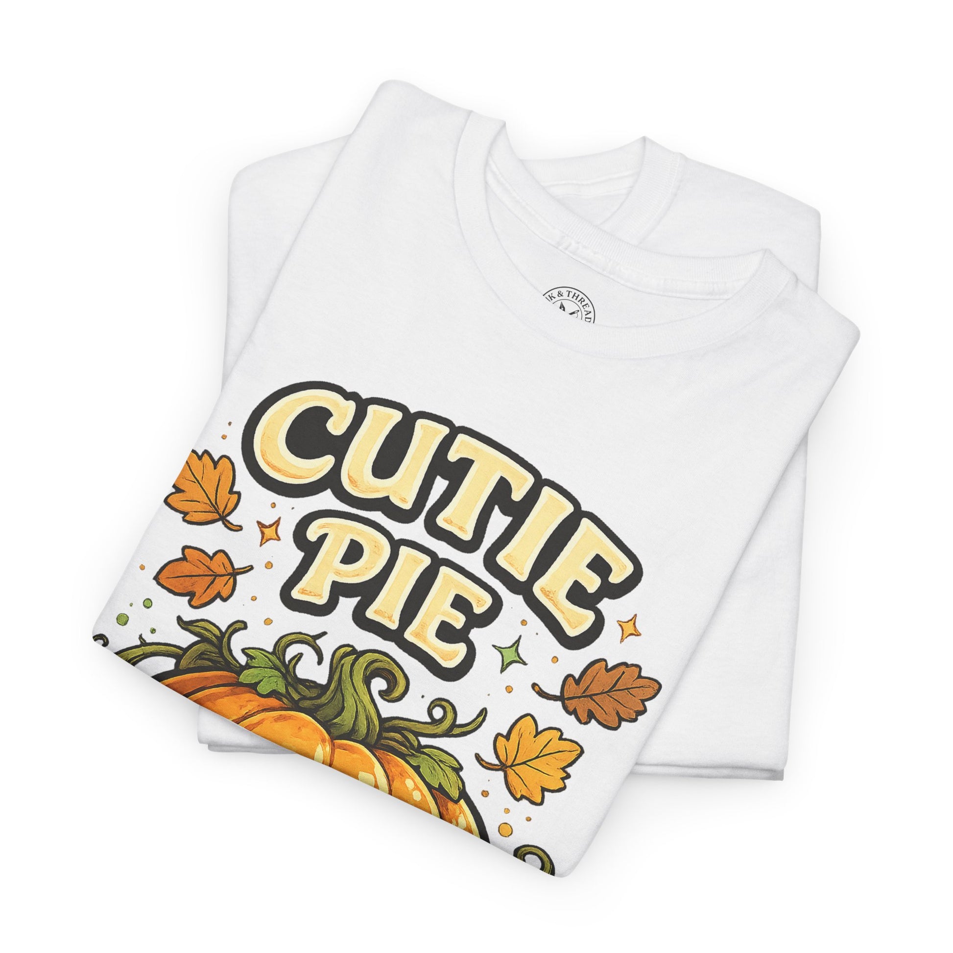 Cutie Pie Pumpkin Halloween T-Shirt in White - Folded View with Autumn Leaves Design