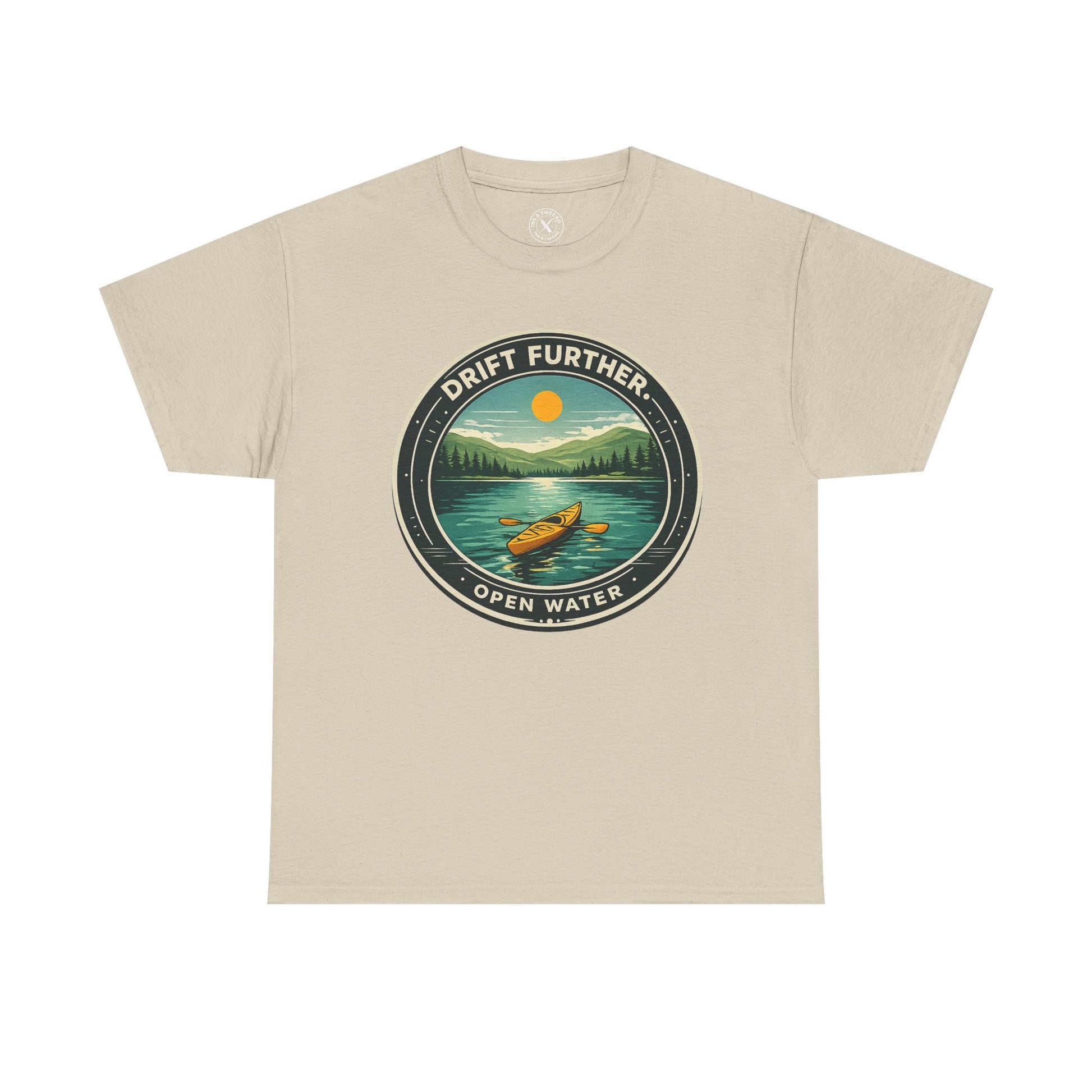 Sand beige unisex t-shirt featuring Drift Further Open Water kayaking circular badge graphic with canoe on lake and sun design