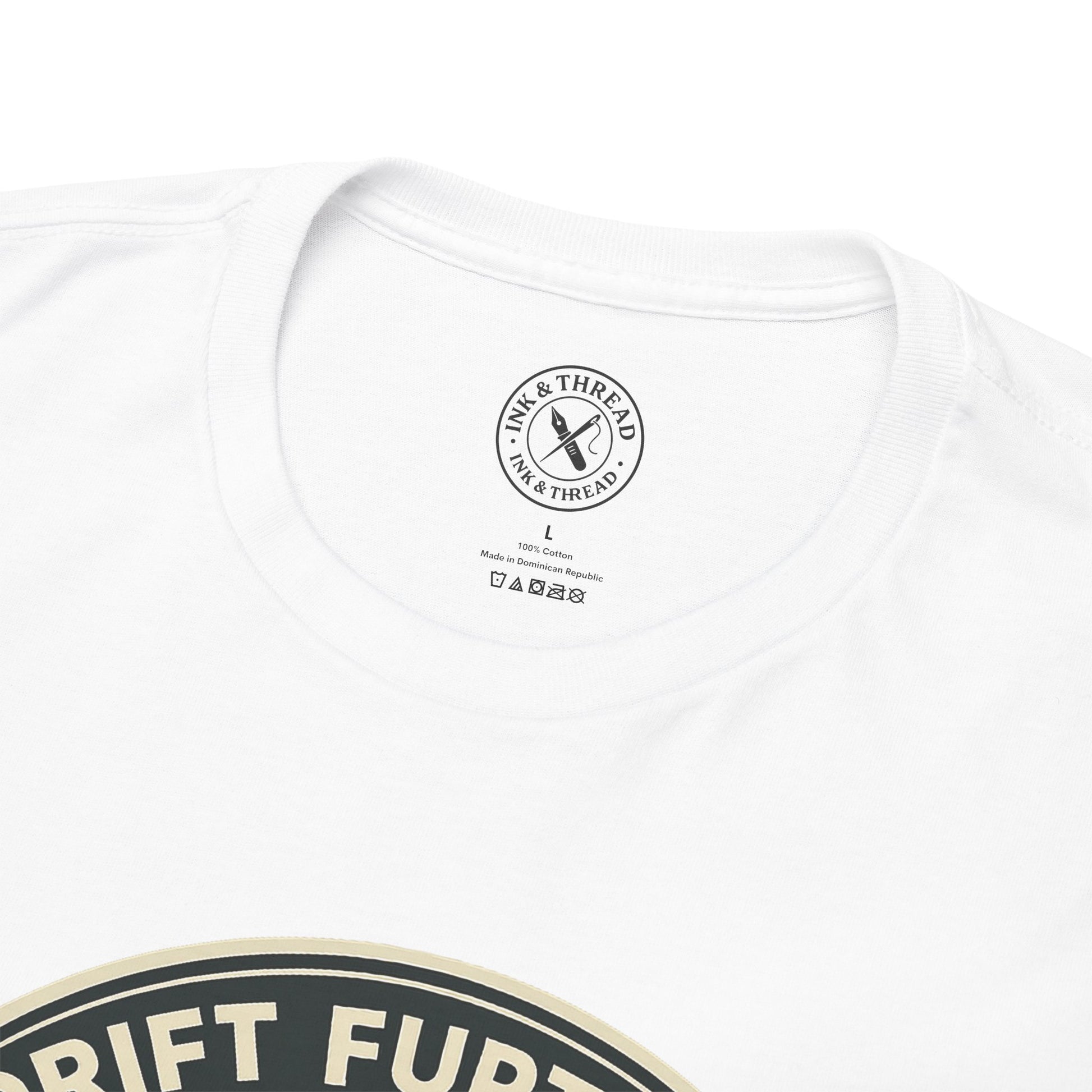 Close-up of Ink and Thread UK branded inner neck label on white t-shirt with Drift Further kayaking graphic design