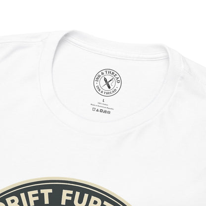 Close-up of Ink and Thread UK branded inner neck label on white t-shirt with Drift Further kayaking graphic design