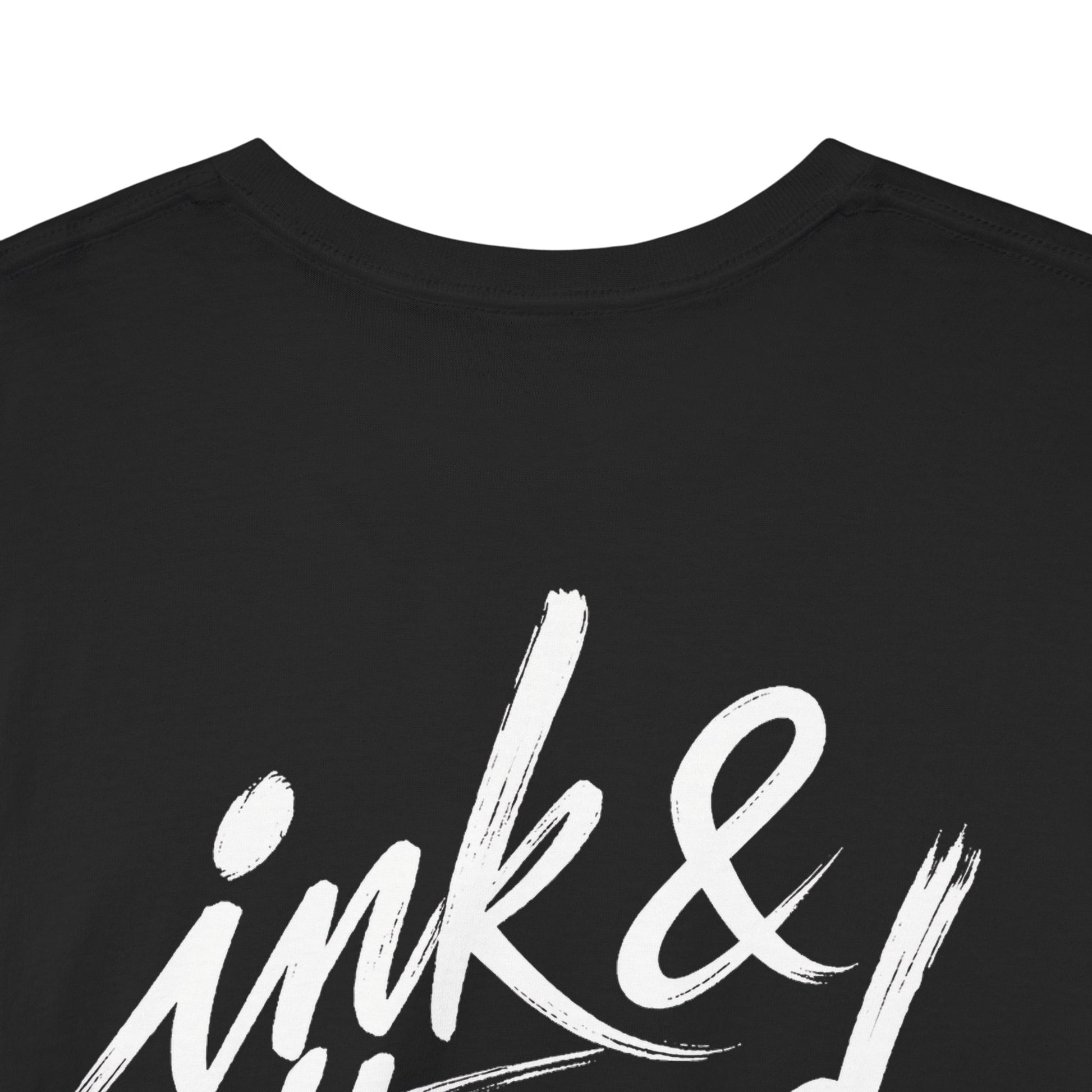 Close-up of Ink & Thread UK black t-shirt back showing large white brush script logo detail