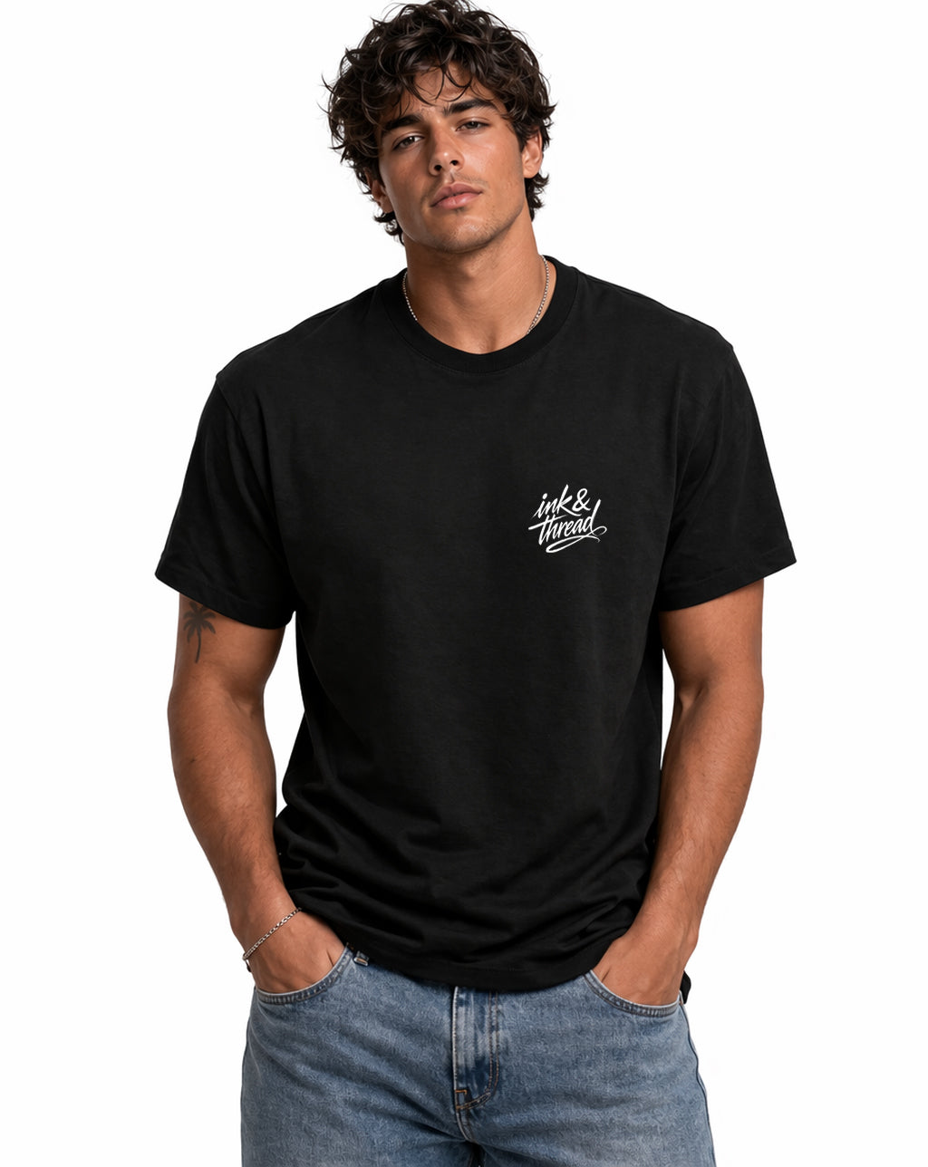 Male model wearing Ink & Thread UK black t-shirt from the front with script logo on chest
