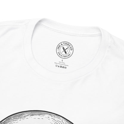 Close-up of Ink and Thread UK branded neck label on white t-shirt showing size tag and care instructions