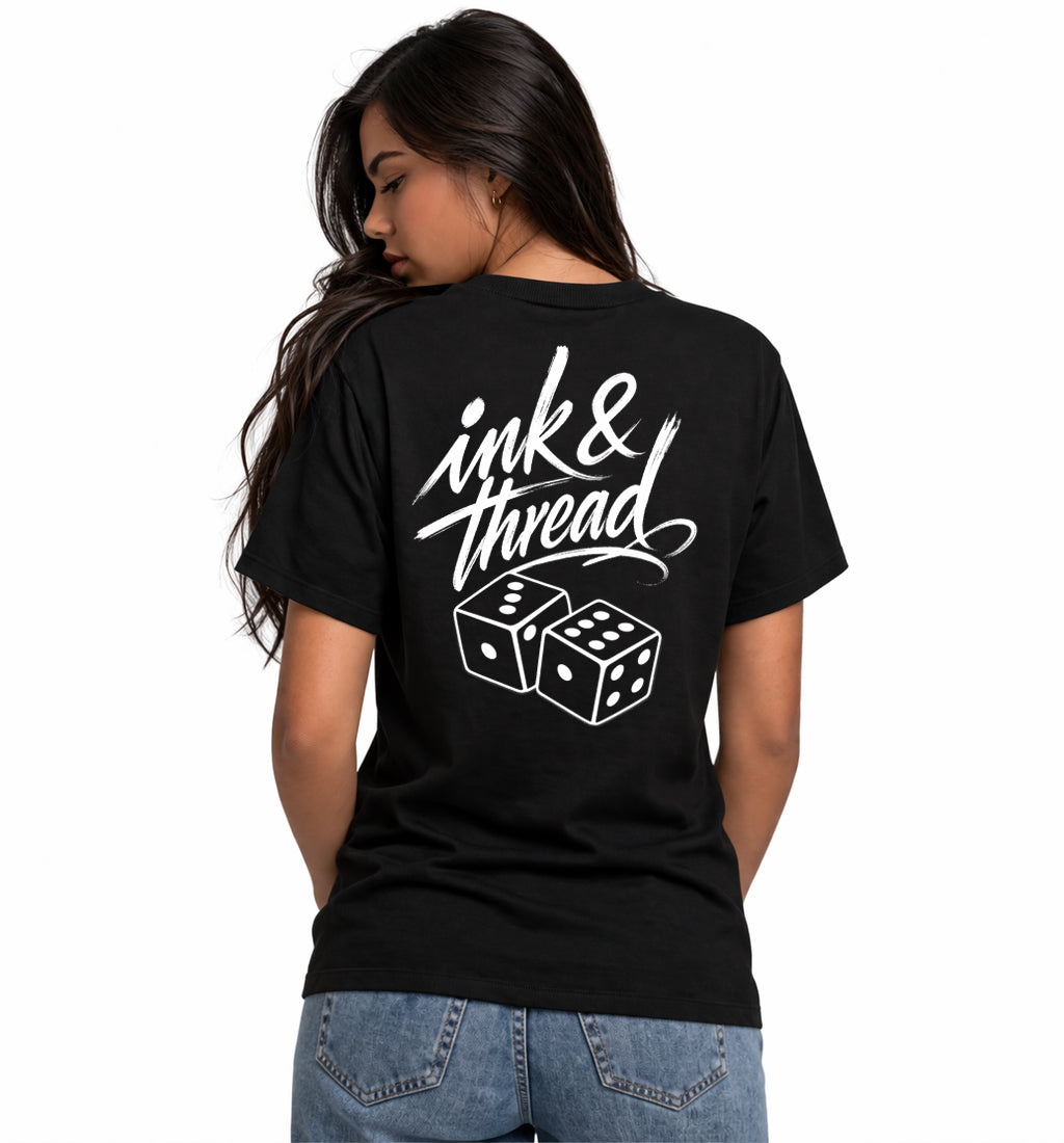Woman model wearing Ink & Thread UK black t-shirt from the back showing script logo and dice graphic design