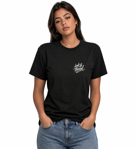 Woman model wearing Ink & Thread UK black t-shirt from the front with script logo on chest and dice design