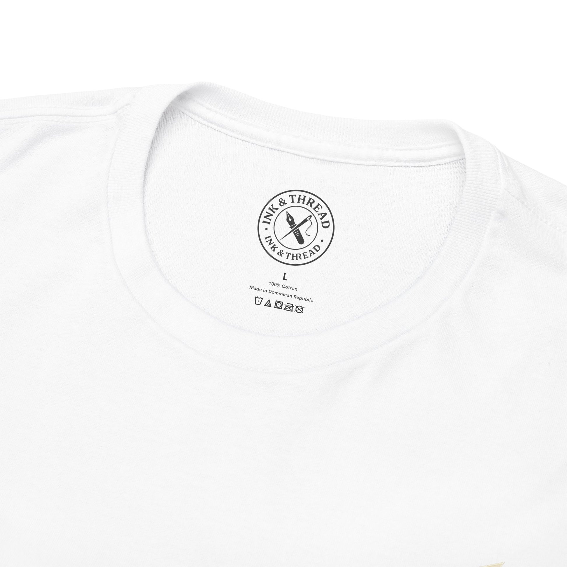 Close-up of Ink & Thread UK branded inner neck label on white t-shirt showing Higher No Shortcuts brand logo and care instructions