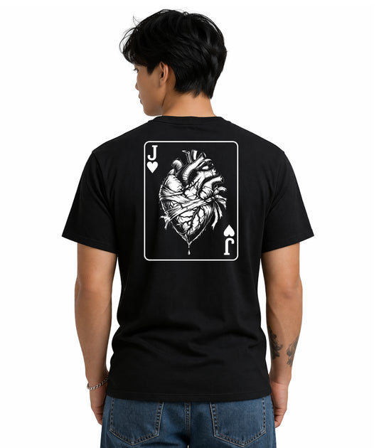 Male model showing back of black t-shirt with Jack of Hearts playing card design featuring anatomical heart illustration