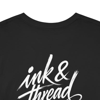 Back close-up of black t-shirt with large Ink and Thread brush script calligraphy print on white background