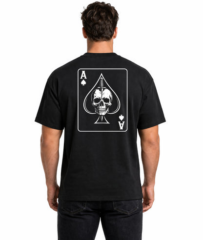 Male model showing back of black t-shirt with Ace of Spades playing card design featuring skull and dagger illustration on white background
