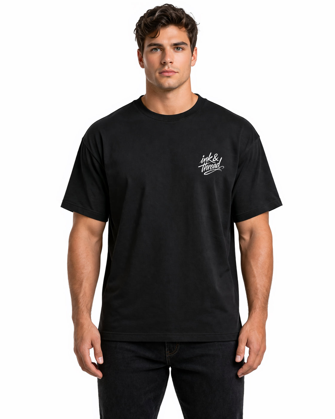 Male model wearing black t-shirt with Ink and Thread script logo on left chest against white background