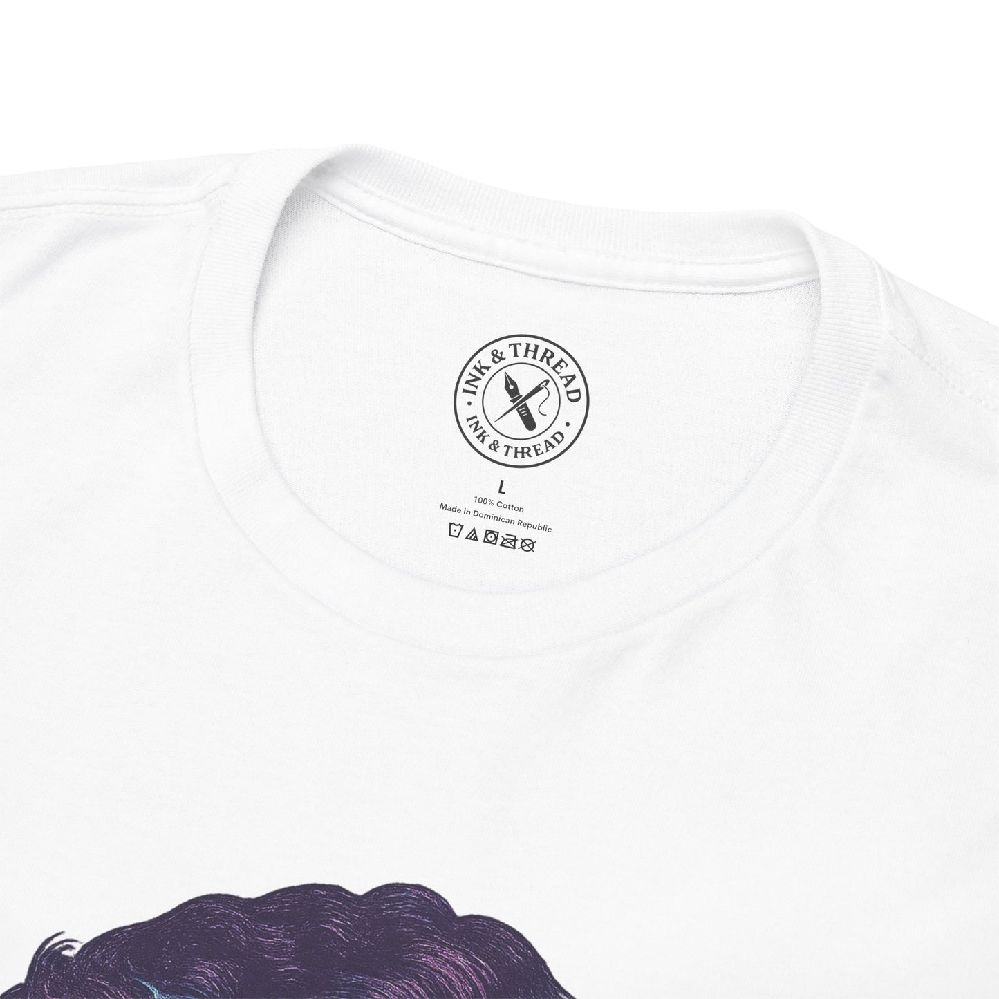 Close-up of Ink and Thread UK branded neck label on white t-shirt showing quality and care details