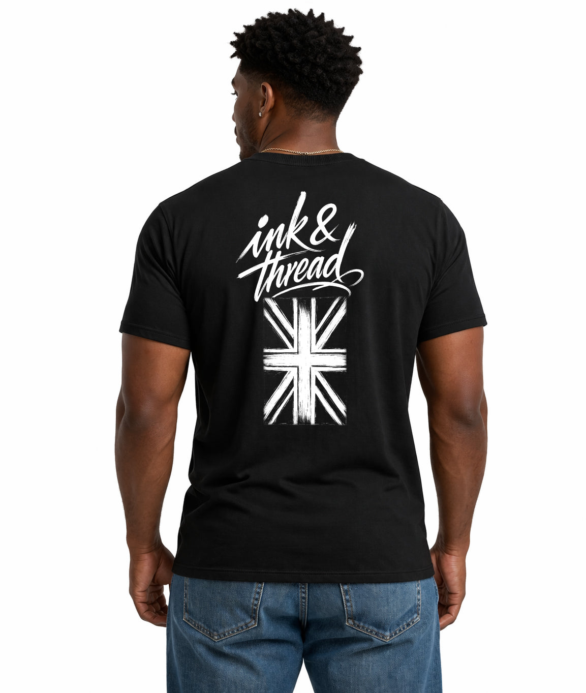 Male model showing back of black t-shirt with Ink and Thread script calligraphy and Union Jack flag illustration on white background