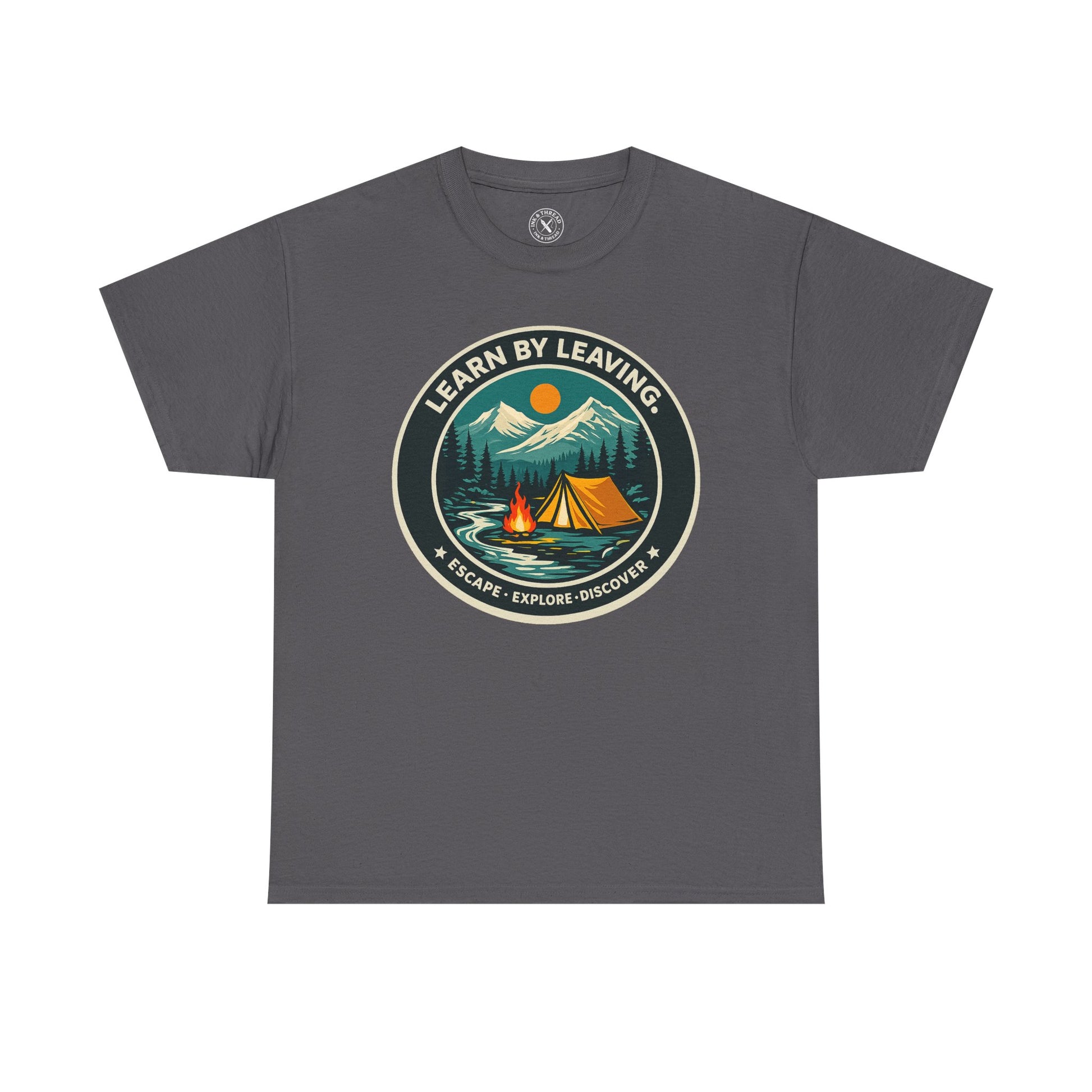 Charcoal grey unisex t-shirt featuring Learn By Leaving camping circular badge graphic with tent, campfire, mountains and escape explore discover design