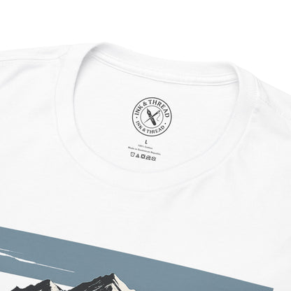Close-up of Ink and Thread UK branded inner neck label on white t-shirt with Push Higher mountain graphic design