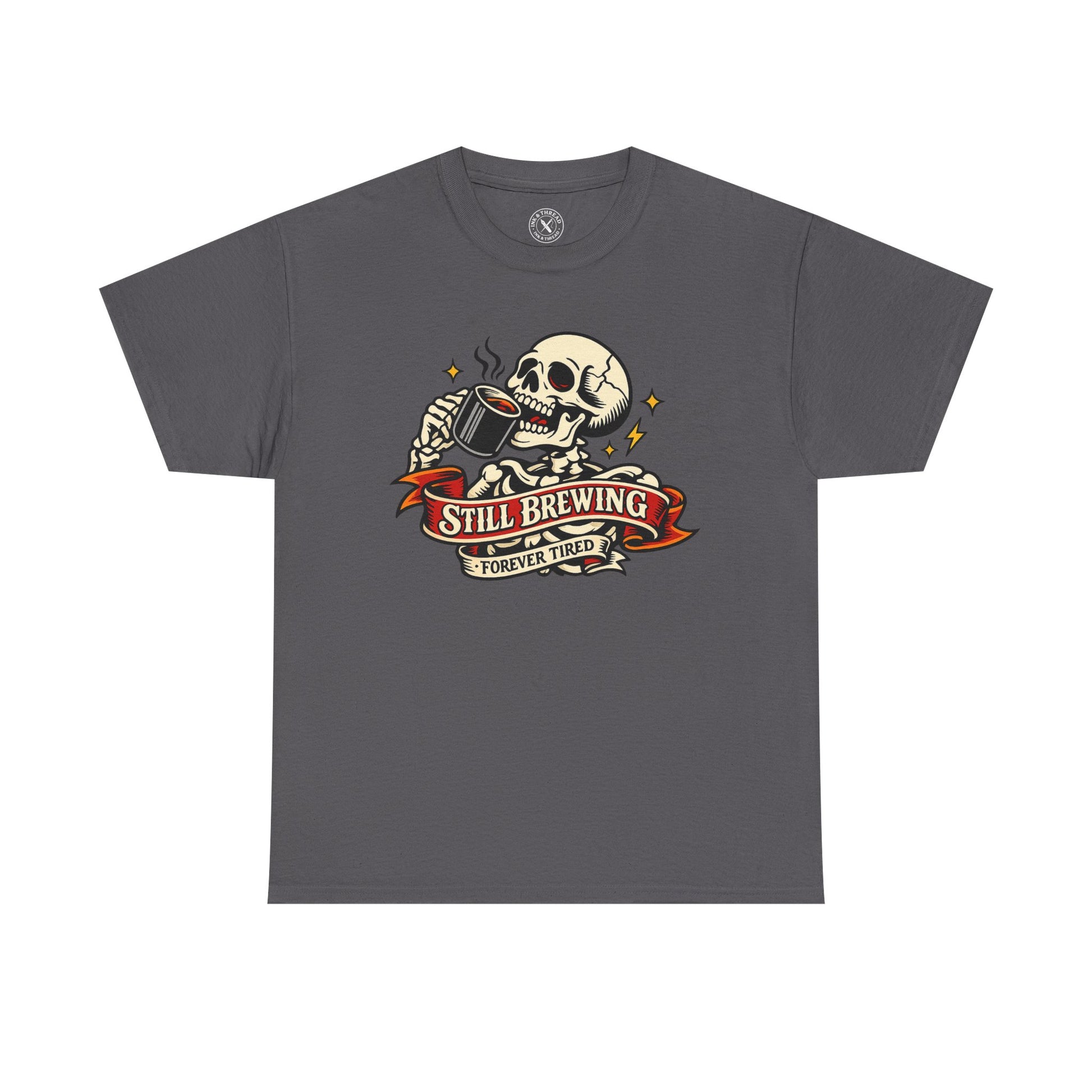 Charcoal grey t-shirt with a skull and coffee cup graphic and Still Brewing Forever Tired text on a white background