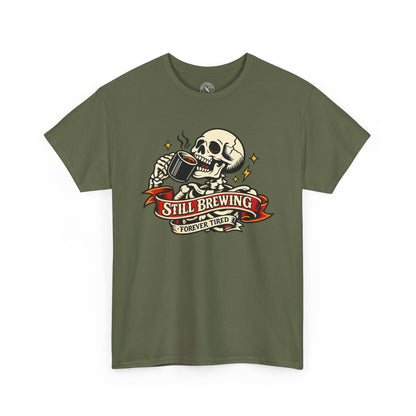 Green t-shirt with a skull and coffee cup graphic and 'Still Brewing Forever Tired' text on a white background.