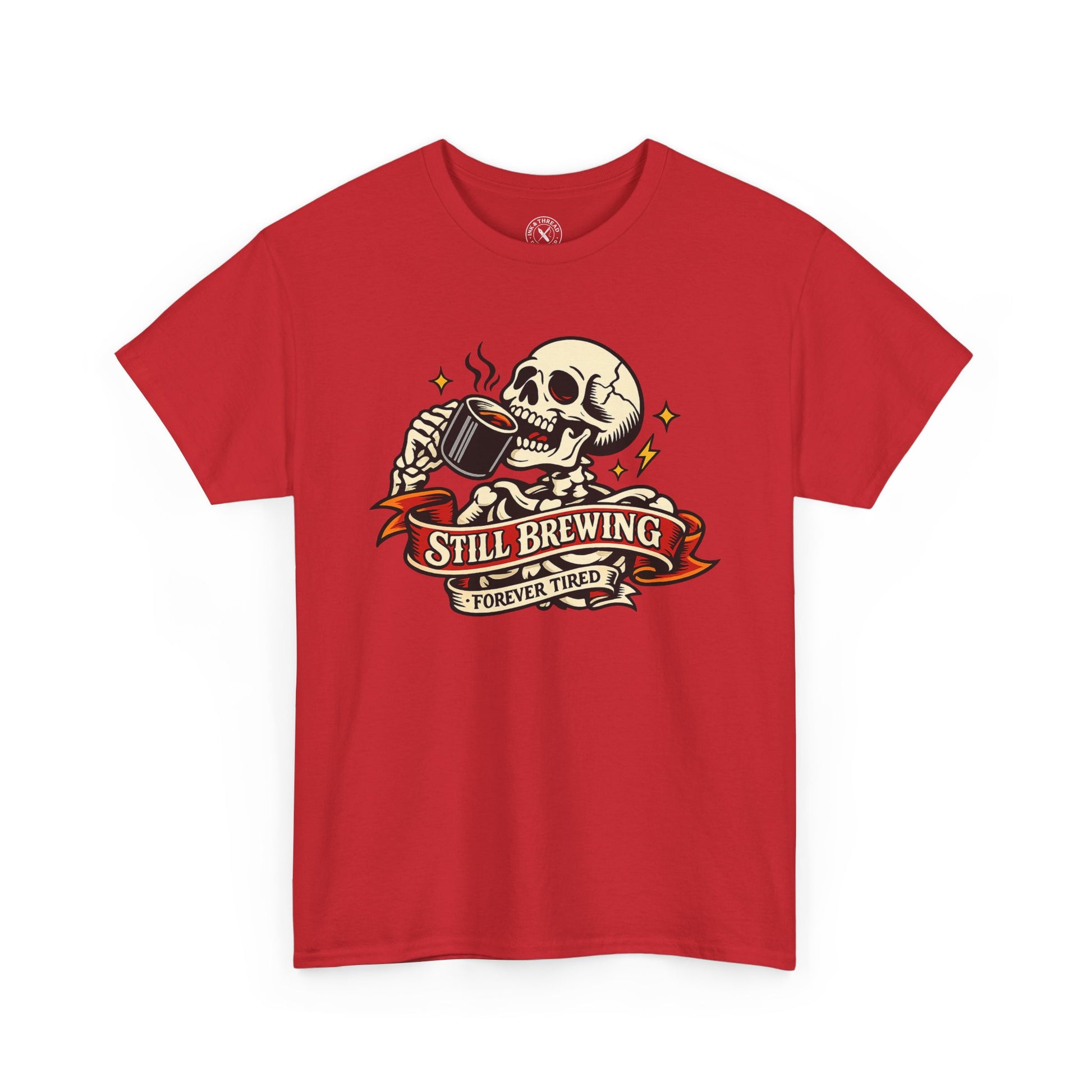 Red t-shirt with a skull and coffee cup graphic and 'Still Brewing Forever Tired' text on a white background.